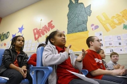 Brooklyn Jones, 11, center, and fellow students at Minadeo School in Squirrel Hill use Skype on Thursday to talk with students at Minadeo School in Italy.