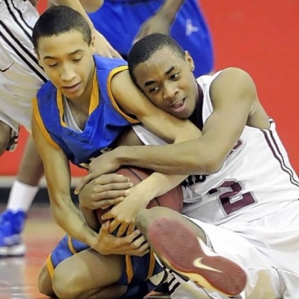 East Allegheny's Jordan Williams fights for a loose ball against Ambridge's Stephon McGinnis Friday.