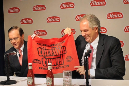 At a press conference Thursday, Alex Behring, right, managing partner at 3G Capital was presented with a Heinz red Terrible Towel by William R. Johnson, chairman, president and CEO of Heinz.