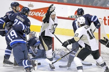 Craig Adams celebrates his goal with Tanner Glass (10) against Jets goaltender Ondrej Pavelec in the first period Friday in Winnipeg, Manitoba.