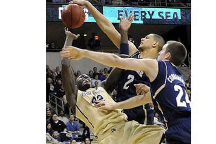 Notre Dame forward Zach Auguste blocks a shot by Pitt forward Talib Zanna in the first half at the Petersen Events Center Monday.