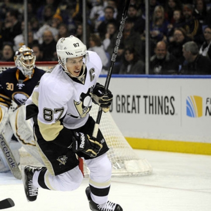 Penguins center Sidney Crosby chases the puck in front of the Buffalo Sabres net in the second period Sunday in Buffalo, N.Y. Crosby had a goal and two assists in the 4-3 victory.