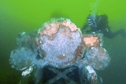 Beth Dalzell of Brick, N.J., explores a steam locomotive (seen from the front), one of two that lie within 20 feet of each other in the Atlantic Ocean off the coast of Long Branch, N.J.