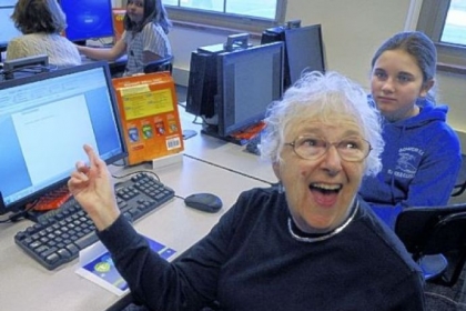 Laryn Finder of Upper St. Clair is happy with her computer help in a class, Computer 101, where seniors learn from Mellon Middle School students of the Mt. Lebanon School District, including Mia Agostinelli, 12, right, a sixth-grader.