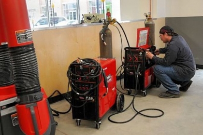 An employee of TechShop sets up mig welders Friday in preparation for the opening of the DIY workshop and fabrication studio for artists, machinists, inventors or dabblers in Bakery Square.