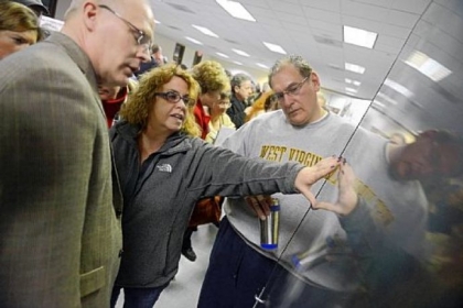 From right, Nick Volakis and Marion McKeegan of Imperial question Randy Forister, senior director of development for the Allegheny County Airport Authority, during an open house Monday at the Findlay Township Activity Center to talk about  proposed Marcellus Shale gas drilling at Pittsburgh International Airport.