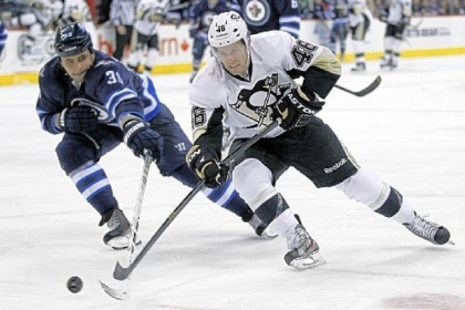 Joe Vitale drives for the net against the Jets' Dustin Byfuglien in the second period Friday in Winnipeg, Manitoba.