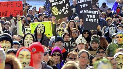 Participants taking part in a rally at the Jefferson County Courthouse demand a more thorough investigation into the alleged rape of a teenage girl by two members of the Steubenville High School football team.