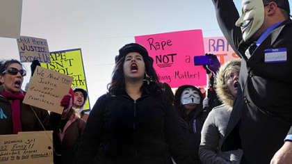 Sable Foster, 23, of East Liverpool, Ohio, shouts Saturday during a rally at Steubenville city hall in Steubenville. Ms. Foster says she is a rape victim, and she shared her story with other participants in the rally.