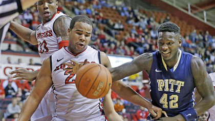 Pitt's Talib Zanna grabs for the ball in front of Rutger's Austin Johnson during the first half.
