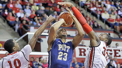 Trey Zeigler has his shot blocked by Rutgers defender Wally Judge (33) as Rutgers' Mike Poole (10) helps out.