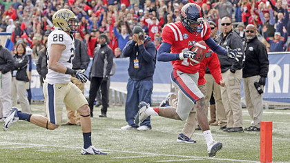 Mississippi wide receiver Vince Sanders scores a touchdown as Pitt defensive back Anthony Gonzalez pursues in the first half of 
Saturday's BBVA Compass Bowl in Birmingham.