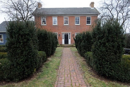 The reb brick walk leads to the front door of the red-brick Georgian-style Colonial in Daugherty, Beaver County.