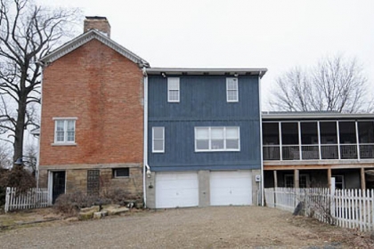 This red-brick Georgian-style Colonial in Daugherty, Beaver County, has a two car garage with access from the rear of the house.