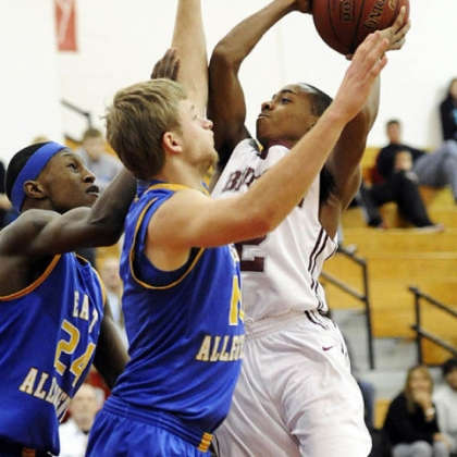 Ambridge's Stephon McGinnis drives to the hoop against East Allegheny's Joel Randolph and Gerald O''Keefe. Matt Freed/Post-Gazette