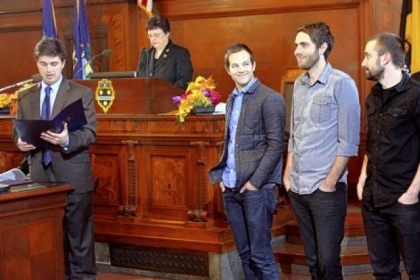 Councilman Corey O'Connor reads a proclamation designating  Feb. 19 as Blood Brother Day in Pittsburgh to honor the work of, from left, director Steve Hoover, producer Danny Yourd and  writer/editor Tyson VanSkiver on the documentary film, "Blood Brother."  The film won the grand jury prize for documentary and the audience award at Sundance.