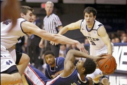 Butler's Andrew Smith, left, and Alex Barlow swarm around Duquesne's Jerry Jones in the first half Tuesday night in Indianapolis.