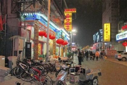 Although Beijing is full of cars, many Chinese in the Wangfujing shopping district still get around on bicycles.
