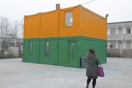 Steel shipping containers have been recycled and stacked for use as rooms at a community center on the outskirts of Beijing. The children of migrants have a place to play or do homework until their parents return from work.