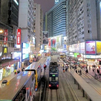 Double-decker buses move through Hong Kong's vibrant "Times Square" district. Although under the sovereignty of the People's Republic of China, the former British colony is allowed to maintain competitive elections, political parties and free enterprise.