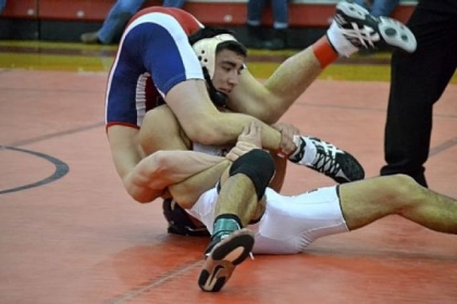 North Hills' Tyler Walker, with Shaler's Jordan McGonigle draped over him during the finals of the 126-pound weight class at the Allegheny County tournament, has won two section titles.