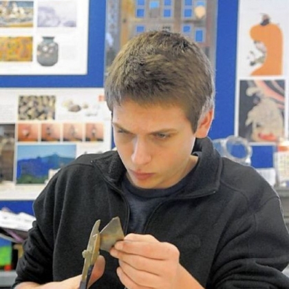 Nicholas Blum, Leah Blum?s brother, cuts out petals from copper.
