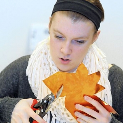 Lainey Lipinski trims around a flower for the sculpture.