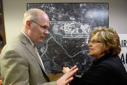 Andrea Fiedler, right, of Imperial in Findlay, questions Randy Forister, senior director of development for the Allegheny County Airport Authority, at an open house in Findlay on Monday, sponsored by the authority and Consol Energy to discuss gas drilling at Pittsburgh International Airport. The county approved a contract with Consol to drill at the airport Tuesday.