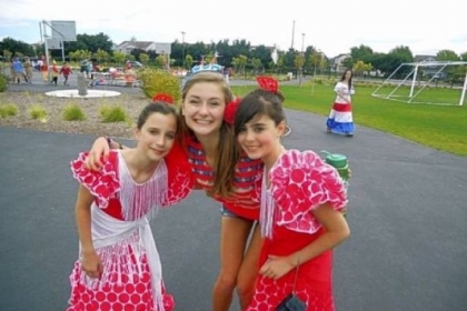 Participants in CISV International, a program that immerses children in the culture of communities around the world, learn that smiles are universal. Rosalie Daniels, 18, a senior at Winchester Thurston School, poses with two 11-year-olds visiting from Spain.
