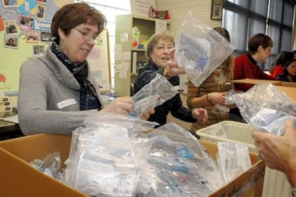 Sharon Deacon, left, and Susie Williams, both of the International Women's Association of Pittsburgh, sort through medical supplies at Global Links in Garfield.