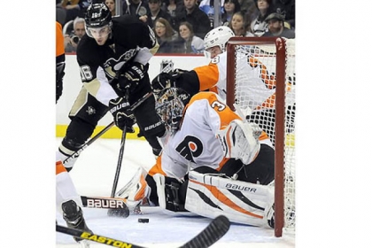 The Penguins' Brandon Sutter scores the tying goal against Flyers goaltender Ilya Bryzgalov in the third period at Consol Energy Center Wednesday night.