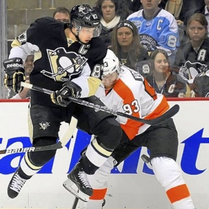 The Penguins' Sidney Crosby works the pucks along the boards against the Flyers' Jakub Voracek in the first period  Wednesday night at Consol Energy Center.
