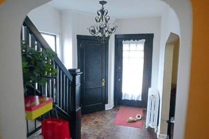 A full-view front door leads to a 13- by 8-foot entry with dark parquet floors.