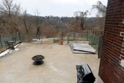 The patio provides views of the hills and valleys below.