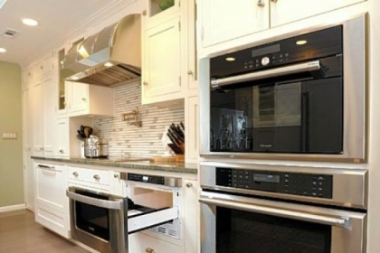 A microwave is in a drawer that's also under a counter.