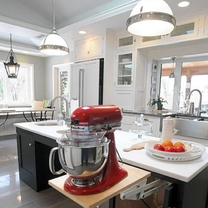 Allison's cherry red KitchenAid mixer swings up on a floating shelf from underneath a counter.
