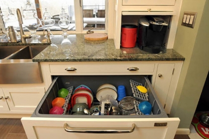 The dishwasher is a drawer among the cabinets in the new Pileggi kitchen. The coffeemaker slides out from its hiding place in a counter-level cabinet.