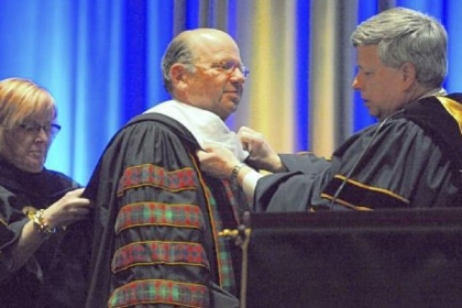 University of Pittsburgh Chancellor Mark A. Nordenberg, right, awards an honorary doctorate of public service to Jared Cohon, president of Carnegie Mellon University, on Friday.