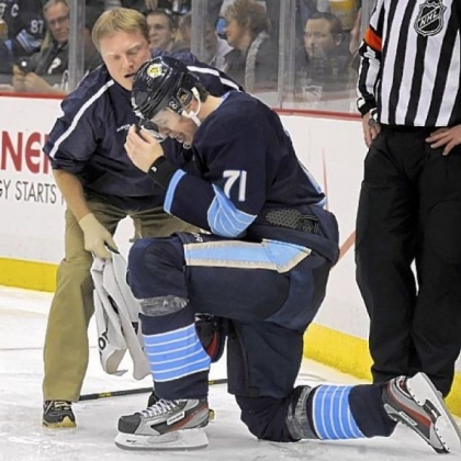 Evgeni Malkin is helped up after taking a hit along the boards in the third period. He left the game and did not return.