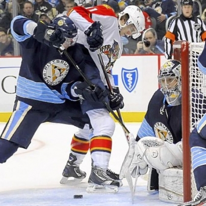 Paul Martin defends as the Panthers' Jonathan Huberdeau tries to shoot against Marc-Andre Fleury in the second period Friday at Consol Energy Center.