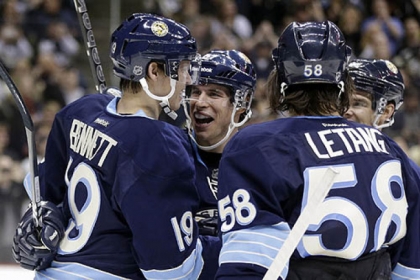 Beau Bennett celebrates his first NHL goal with  Sidney Crosby, and Kris Letang.