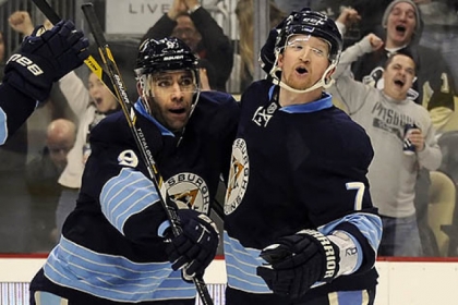 The Penguins' Pascal Dupuis congratulates Paul Martin on a goal against the Lightning in the first period at Consol Energy Center.