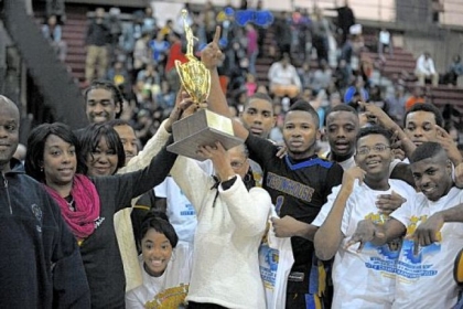 Members of the Westinghouse basketball program celebrate the Bulldogs' victory against Perry for the City League title at Obama Academy High School -- their first City League championship since 1998.