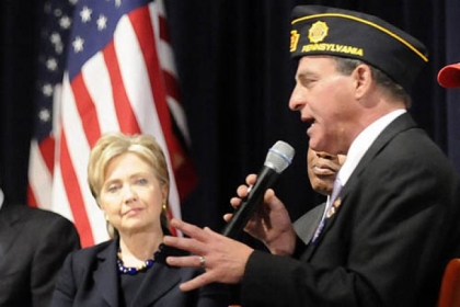 Sen. Hillary Clinton listens as Monroeville mayor and Army veteran Gregory Erosenko talks to a crowd in 2008 at Hopewell High School.