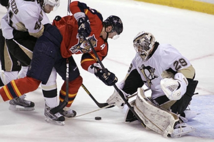The Panthers' Tomas Kopecky looks for the puck as Penguins goalie Marc-Andre Fleury defends during the second period.