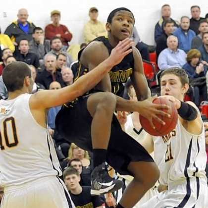 Montour's Justin Hill drives to the basket against Mars' Owen Nearhoof and Matt Getsy Tuesday in a Class AAA semifinal. Montour defeated Mars, 61-52.