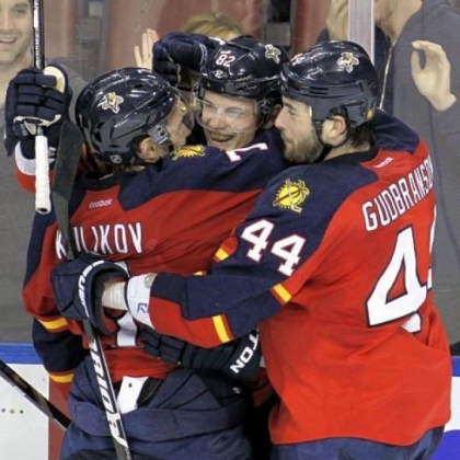 Florida's Tomas Kopecky, center, celebrates with teammates Dmitry Kulikov, left, and Erik Gudbranson (44) after Kopecky's third goal, an empty-netter against the  Penguins in a 6-4 Panthers win.