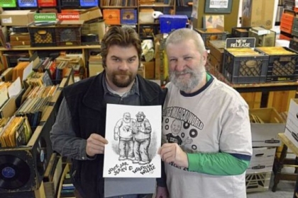 Jerry Weber and his son, Willie, left, of Jerry's Records in Squirrel Hill, with a drawing of them by Robert Crumb. The Webers plan to sell T-shirts featuring the drawing in the early spring.