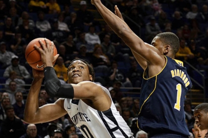 Penn State's Brandon Taylor, left, looks for a shot past Michigan's Glenn Robinson III during the first half of the Nittany Lions' upset victory.