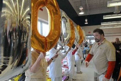Scott Baker arranges balloons at the checkout lines in the Shop 'n Save in Kennedy.